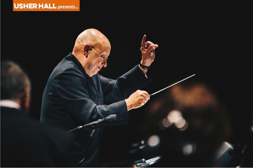 Dennis Russell Davies conducting orchestra