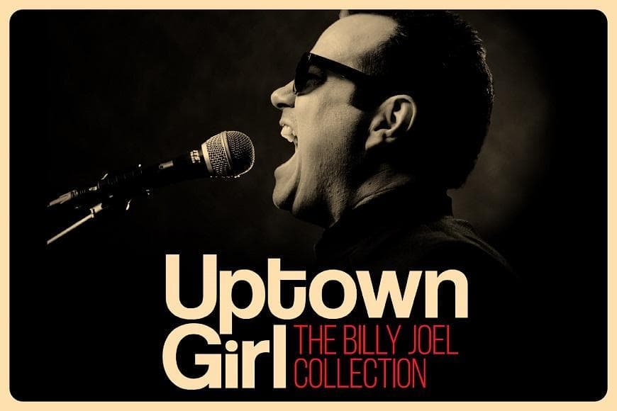 Man wearing sunglasses singing into microphone