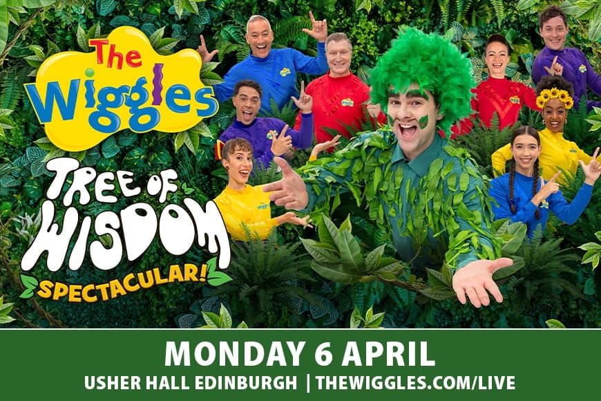 The Wiggles smiling with forest backdrop