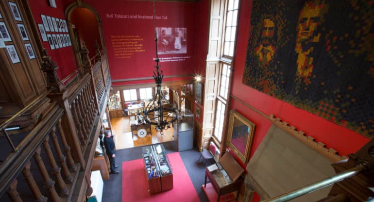 The interior of the historic The Writers' Museum just off the Royal Mile in Edinburgh. The museum features a high ceiling, dark wooden balcony and objects on display