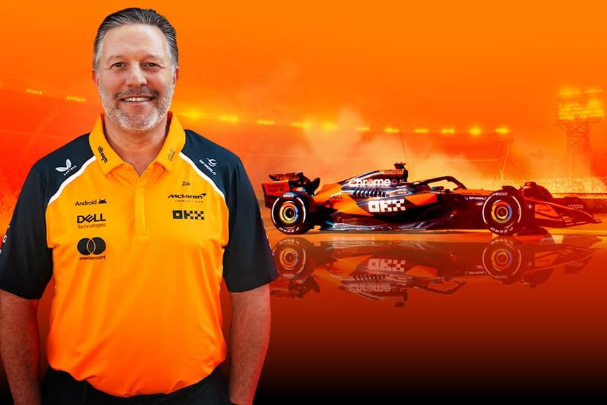 Image of Zak Brown next to F1 car