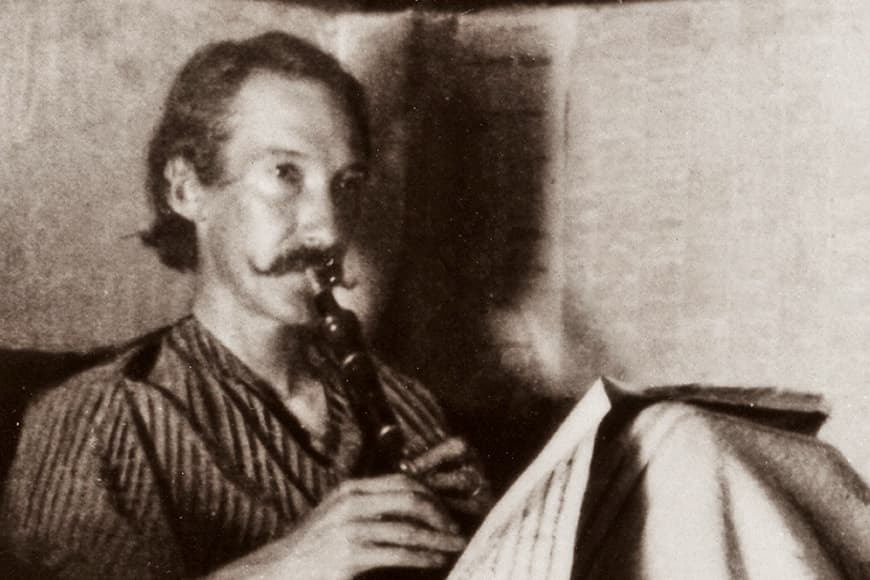 Sepia photo of Robert Louis Stevenson sitting up in bed