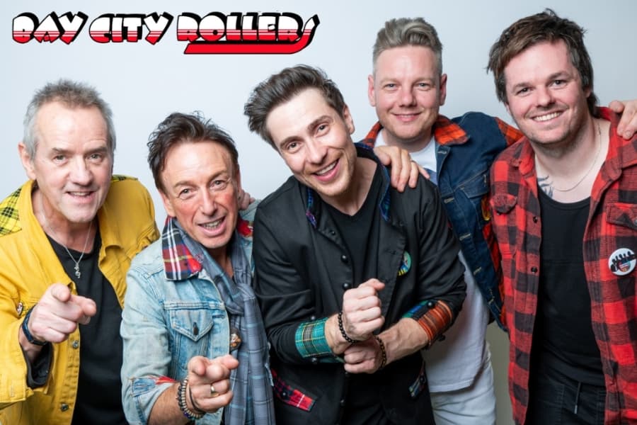 Image shows 5 men smiling