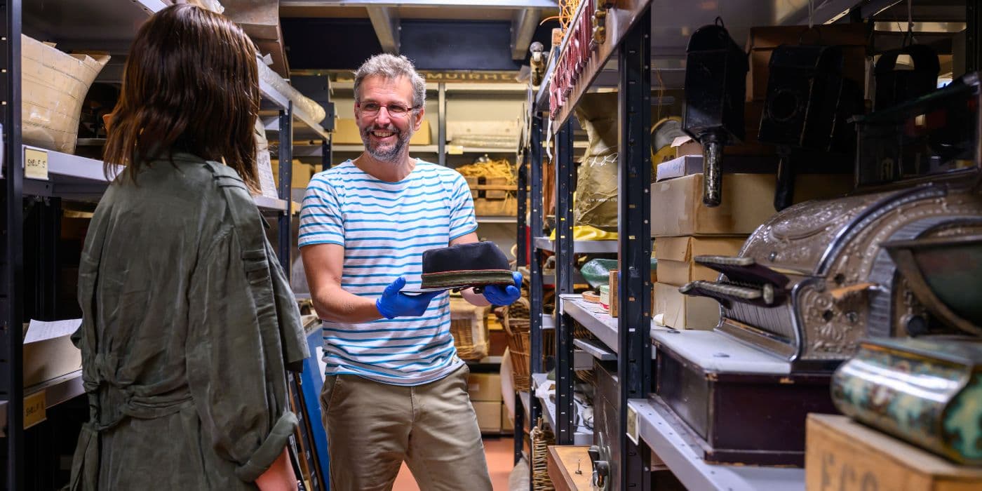 A person being given a tour of the museum collections centre