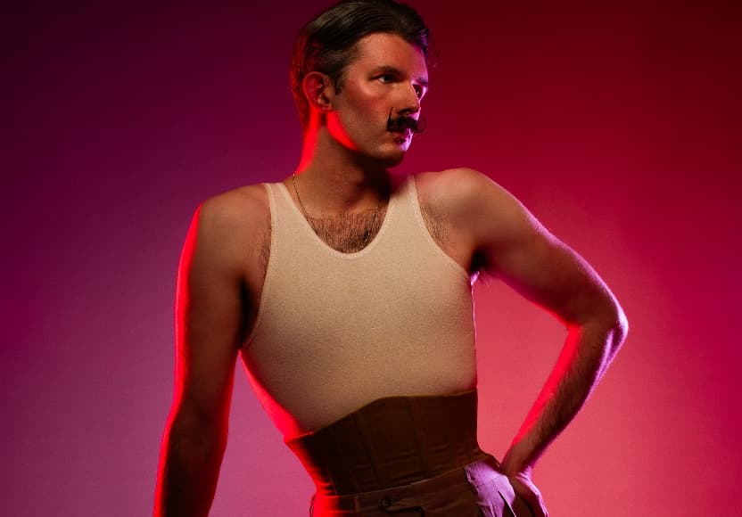 Man in white vest with poirot styled moustache