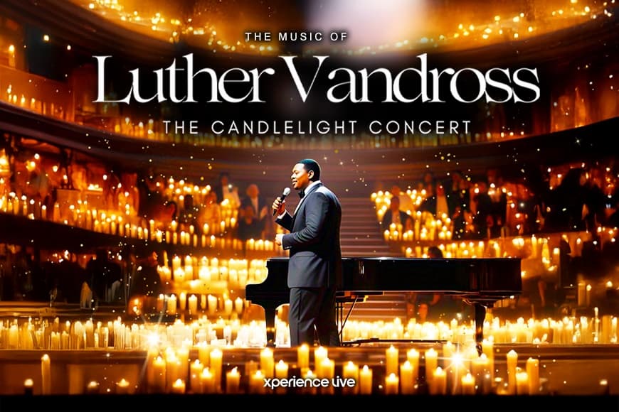 Image of Luther Vandross tribute singing on stage alongside piano and candles