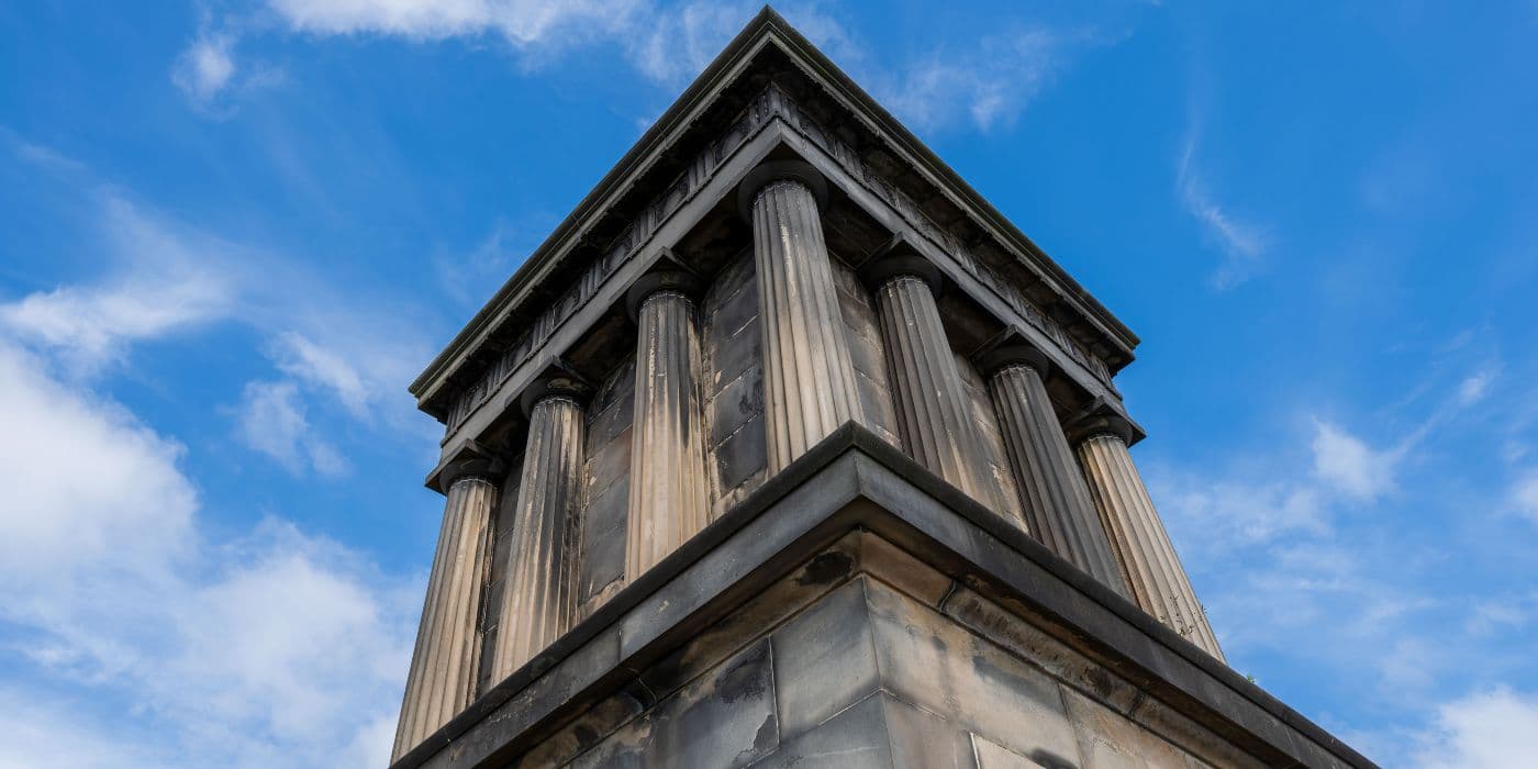 Closeup upward angle of a large Greek/Roman style monument with pillars