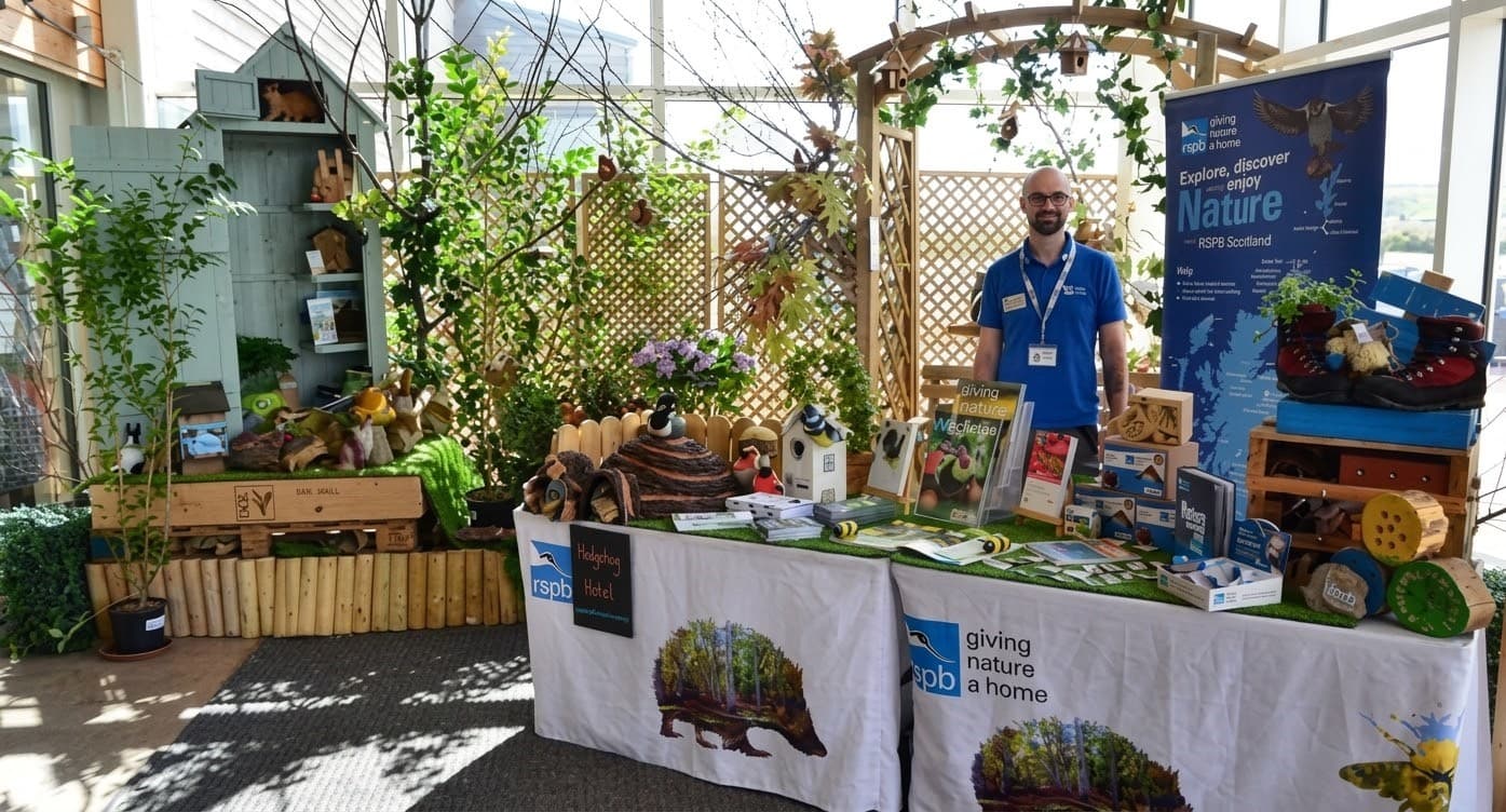 Man standing behind RSPB information stall
