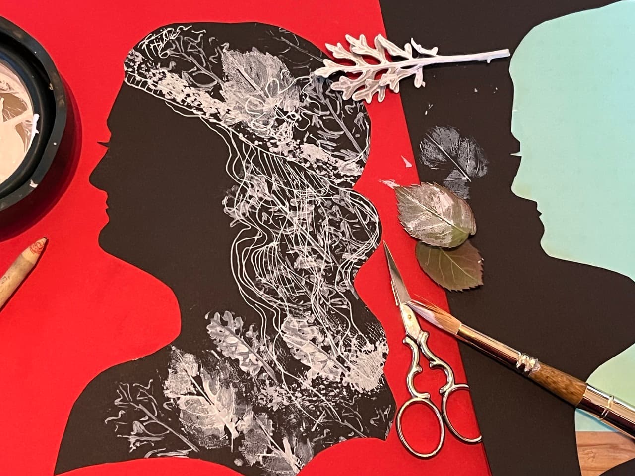 Silhouette cut from black craft paper, with pattern created by pressing painted leaves on the paper
