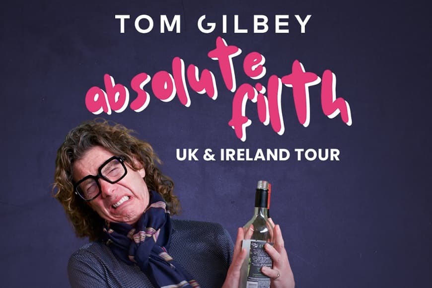 Image of Tom Gilbey holding a bottle of wine