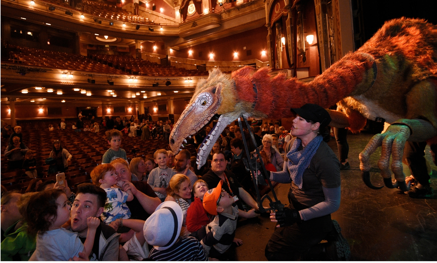 Orange dragon coming out from the stage to meet some of the audience (Capital Theatres). Image by: Greg Macvean