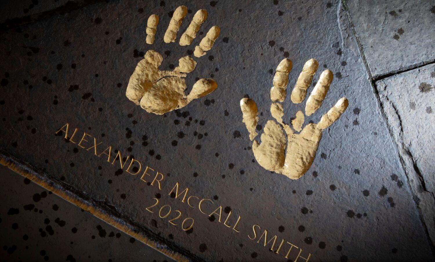 Edinburgh Award 2020 handprints engraved and gilded on a paving stone in the City Chambers Quadrangle.
