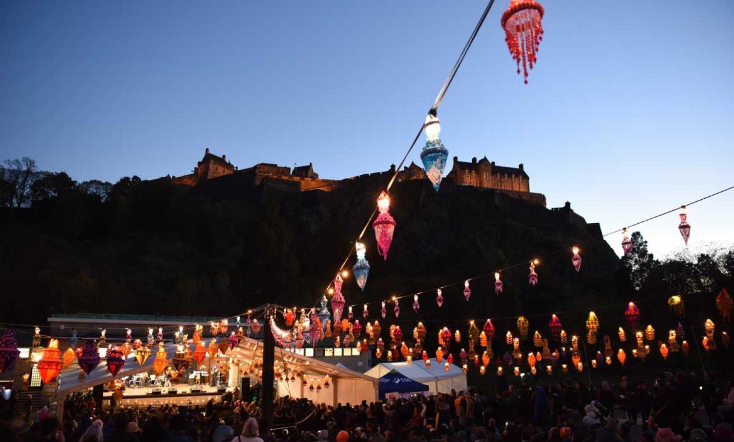 Photo of Edinburgh Castle at night with Edinburgh Diwali lanterns spread across the skyline