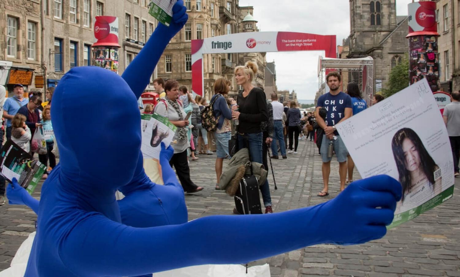 Performers handing out leaflets at Edinburgh Fringe Festival, Royal Mile