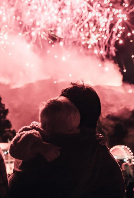 Parents and child at the festival fireworks concert in Princes Street Gardens